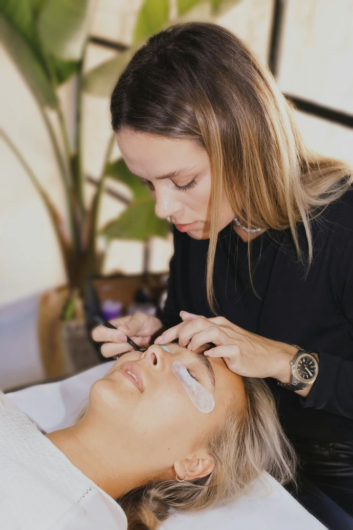 A woman getting a facial mask on her face